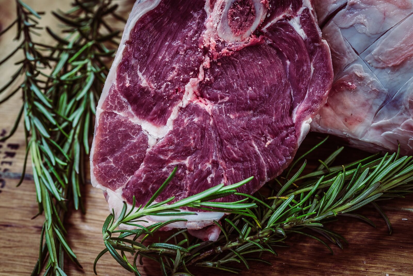 image of raw steak and herbs on board